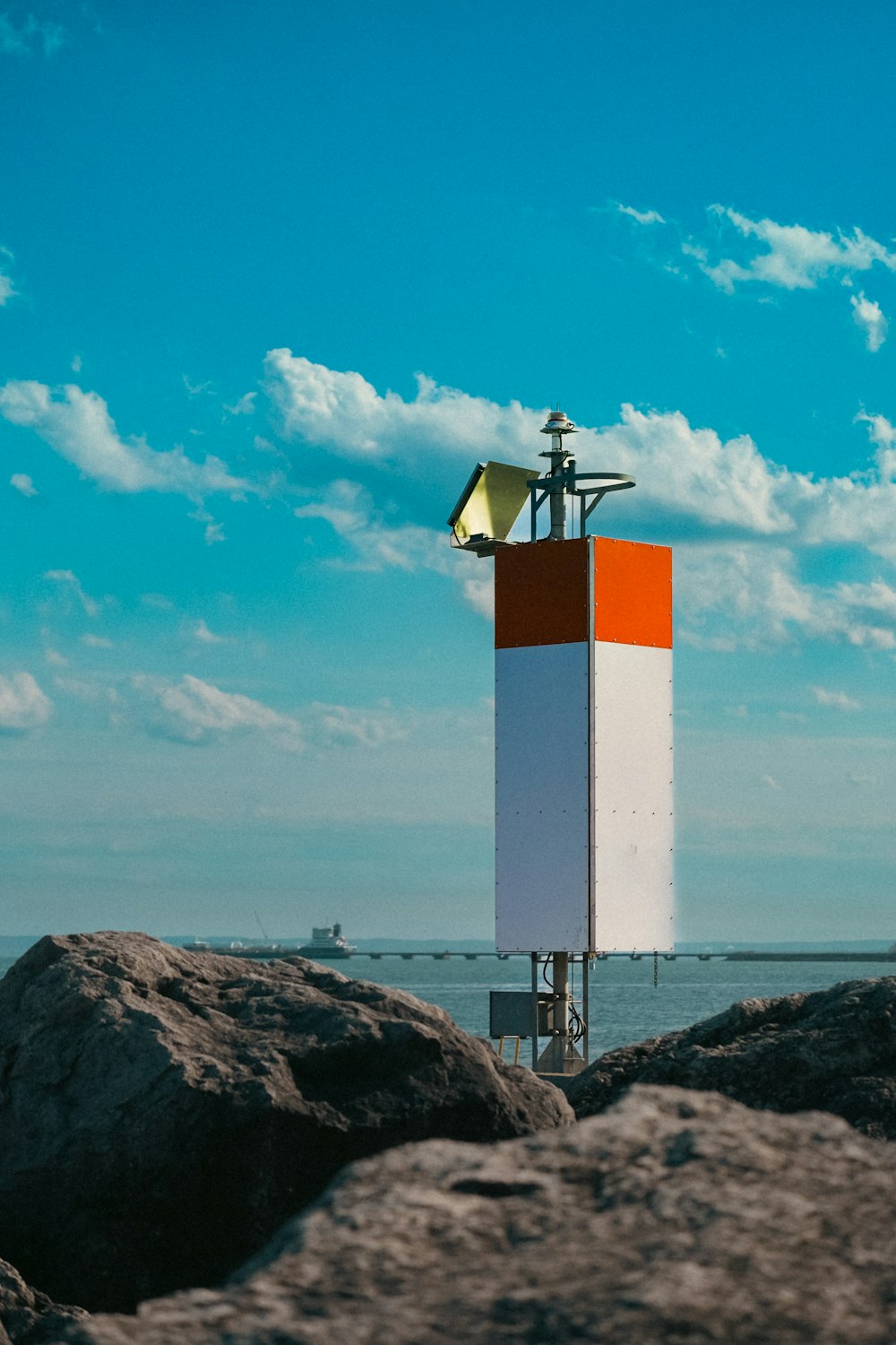 a tall tower sitting on top of a rocky beach