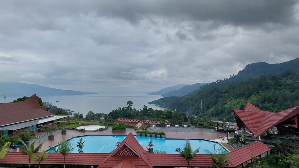 a view of a resort with a pool and mountains in the background