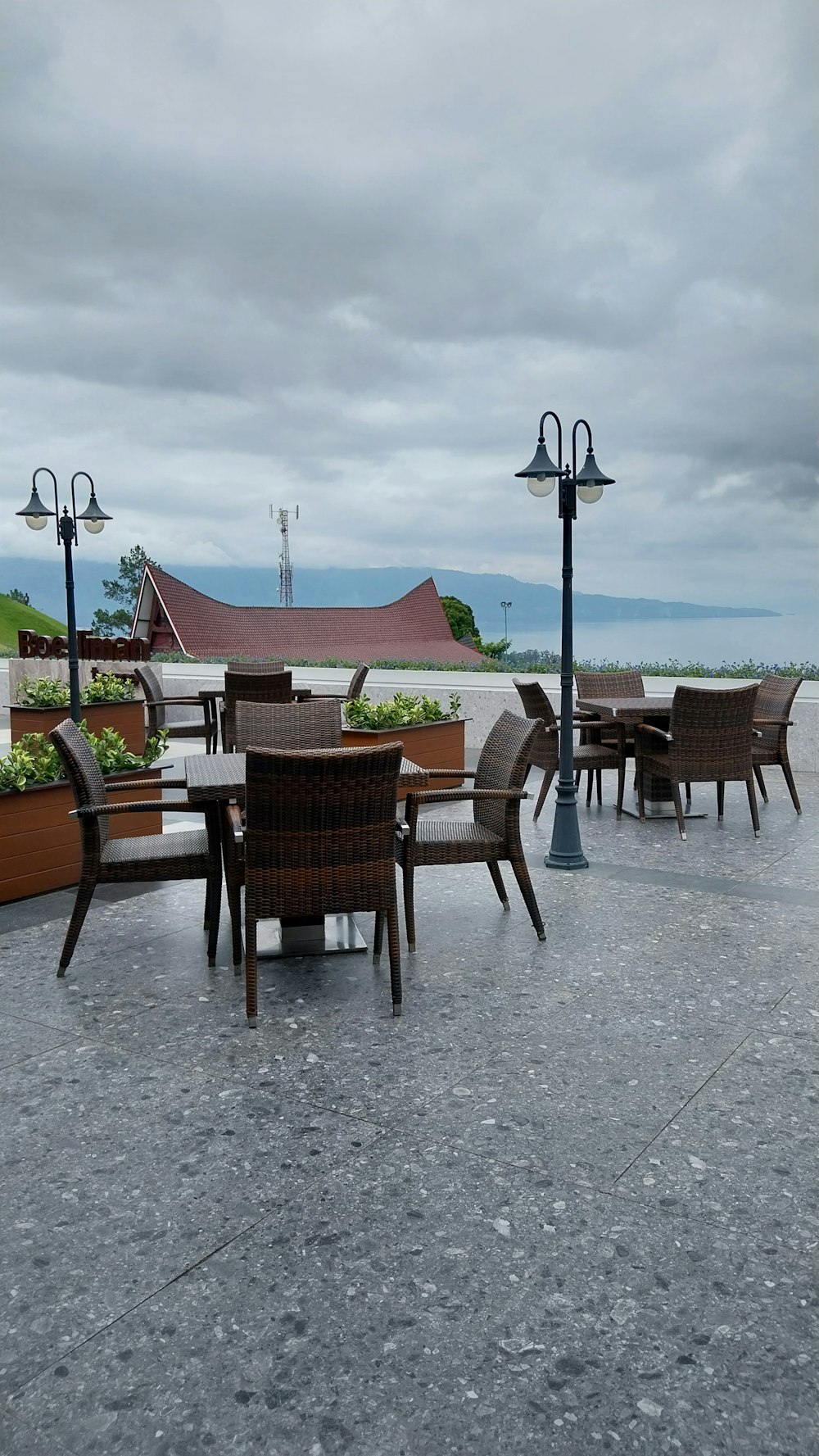 a group of chairs and tables sitting on top of a cement floor