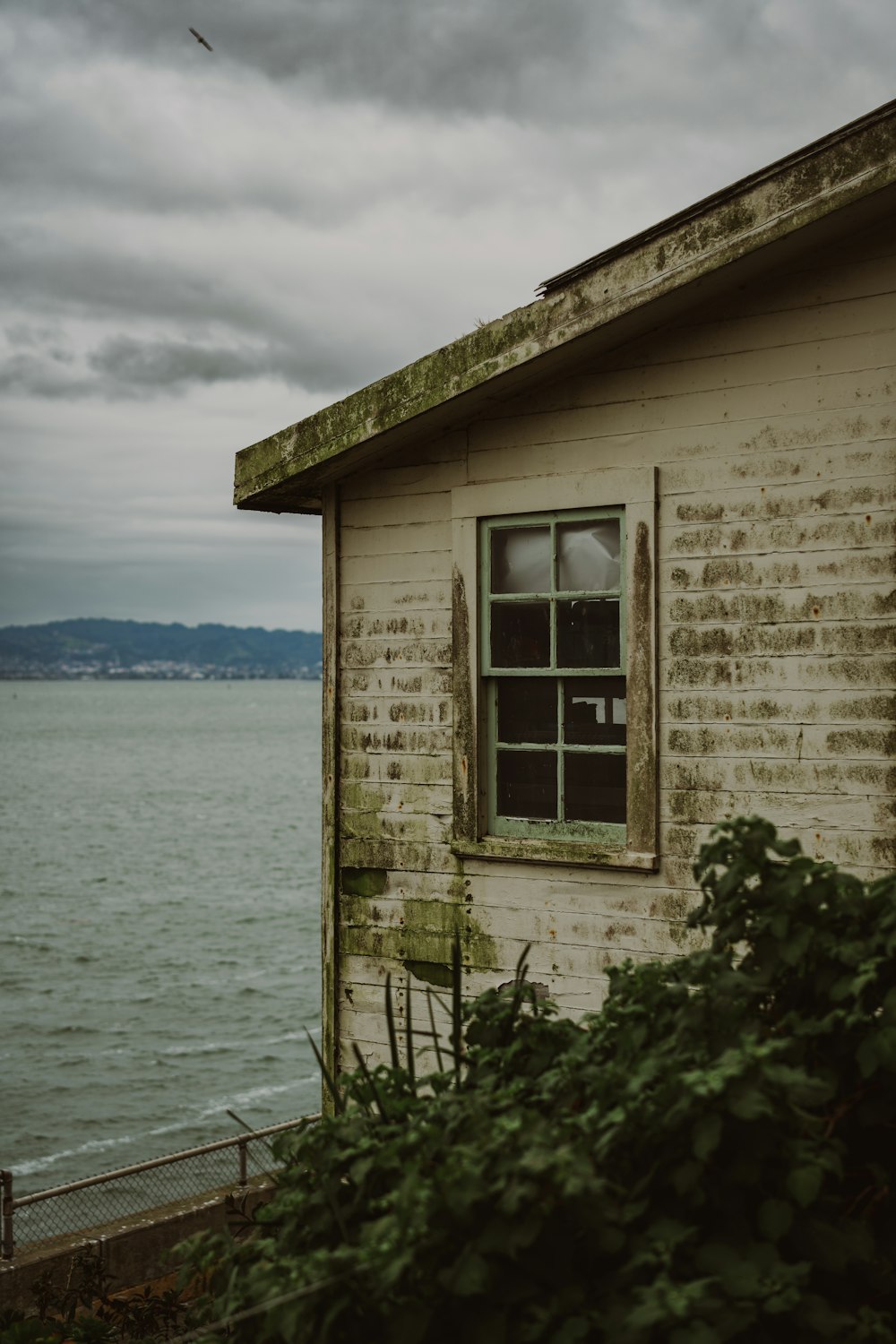 an old building sitting next to a body of water