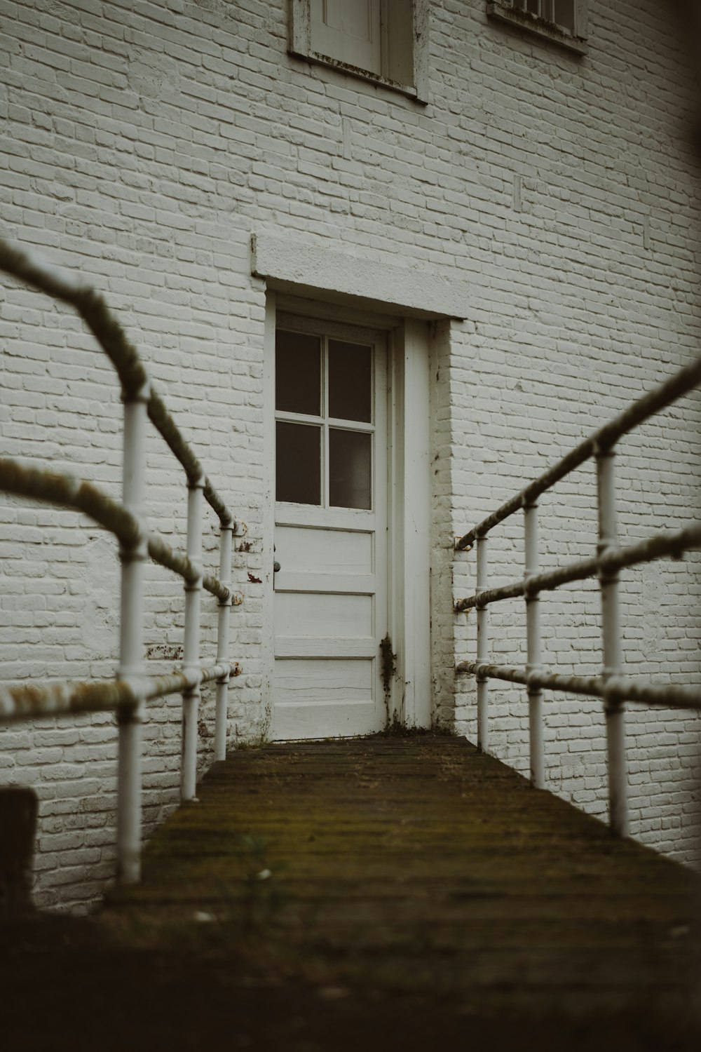 a white door and a white brick building