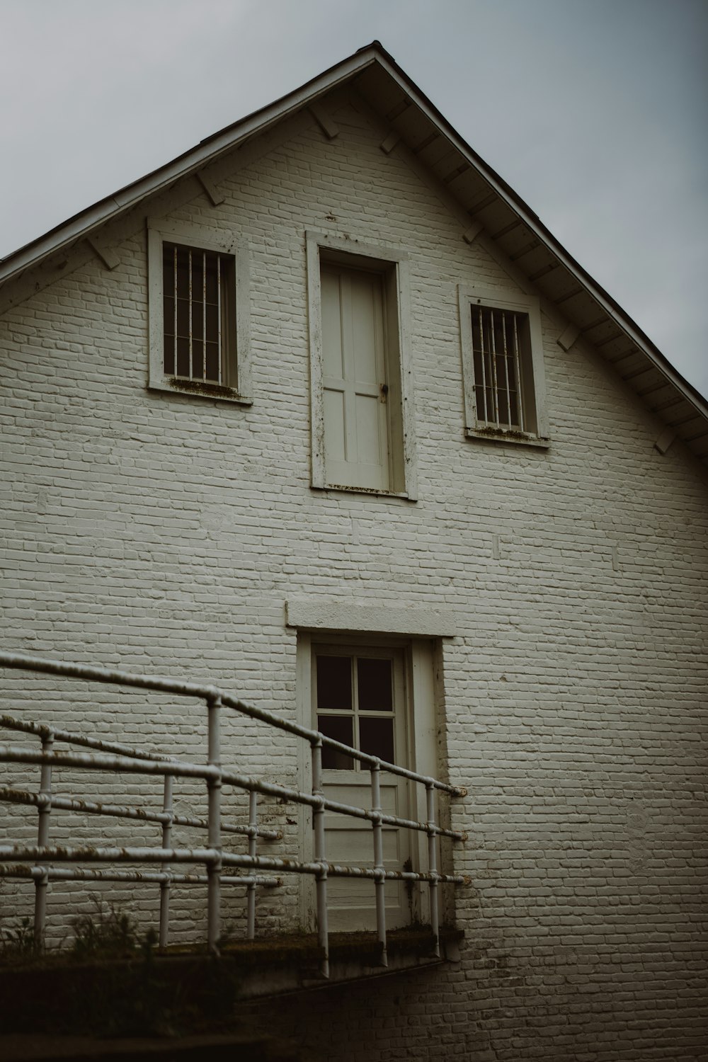 a white brick building with a white door and window