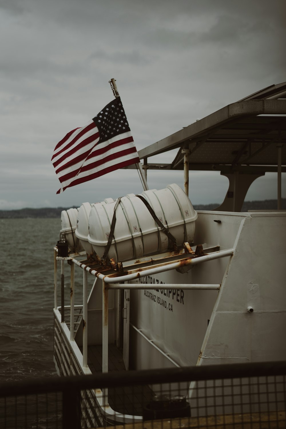 an american flag on a boat in the water