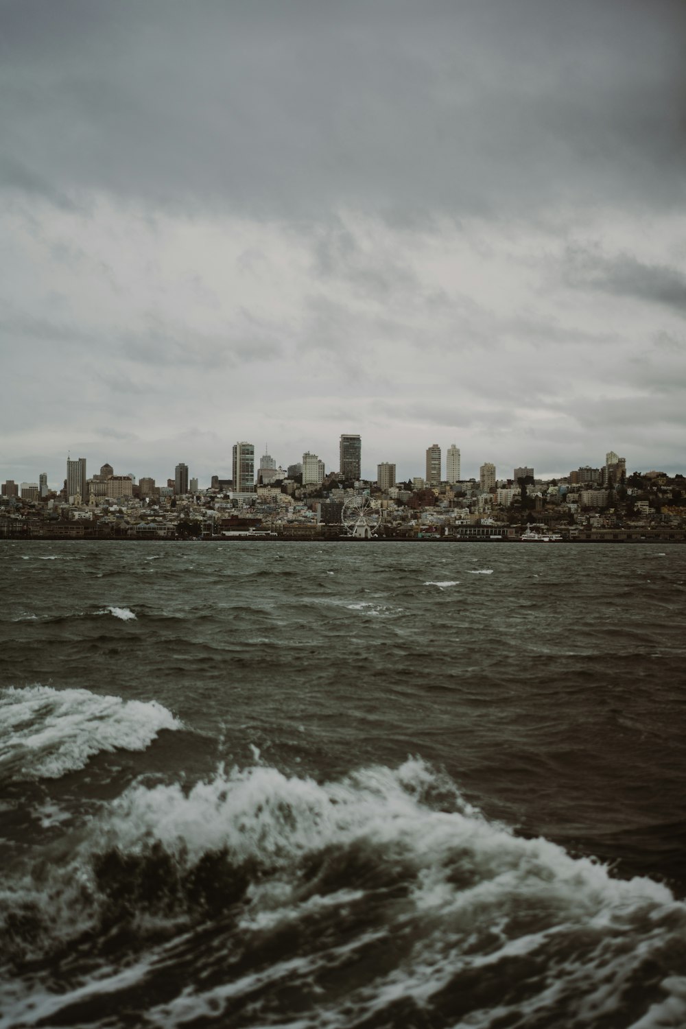 a large body of water with a city in the background