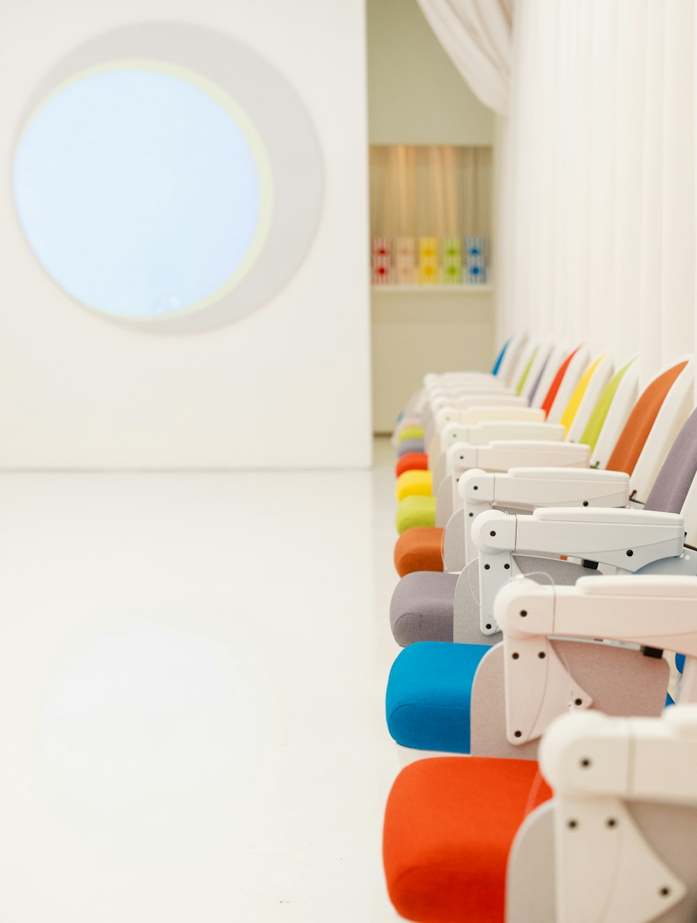 a row of colorful chairs sitting next to each other