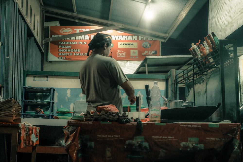 a man standing in a kitchen preparing food