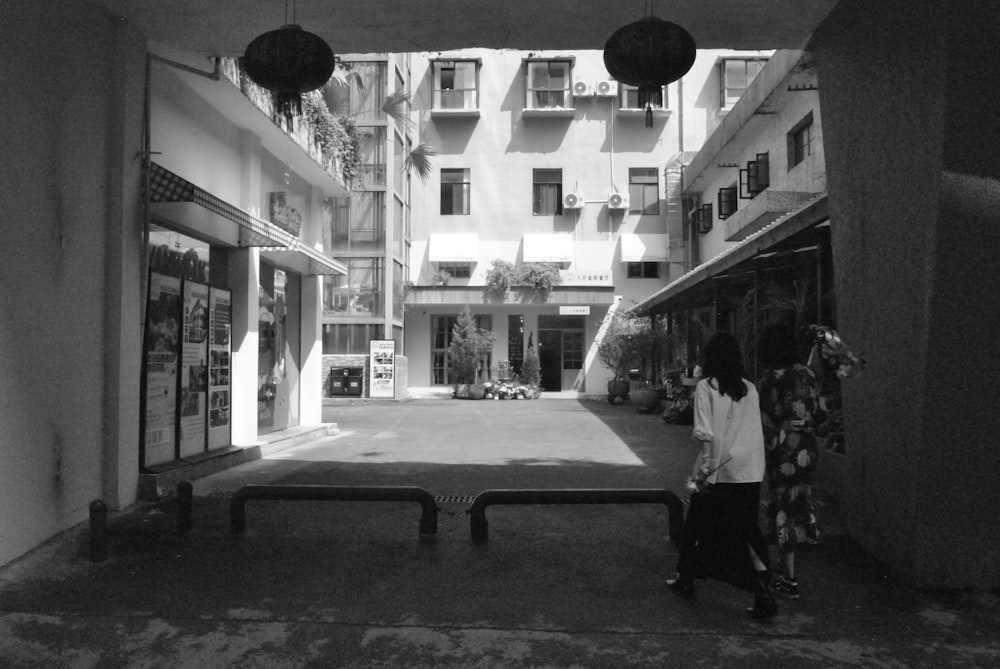 a couple of people that are standing in front of a building