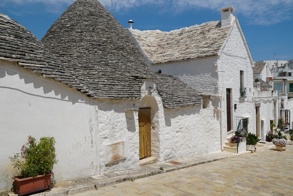 a white building with a brown door and windows