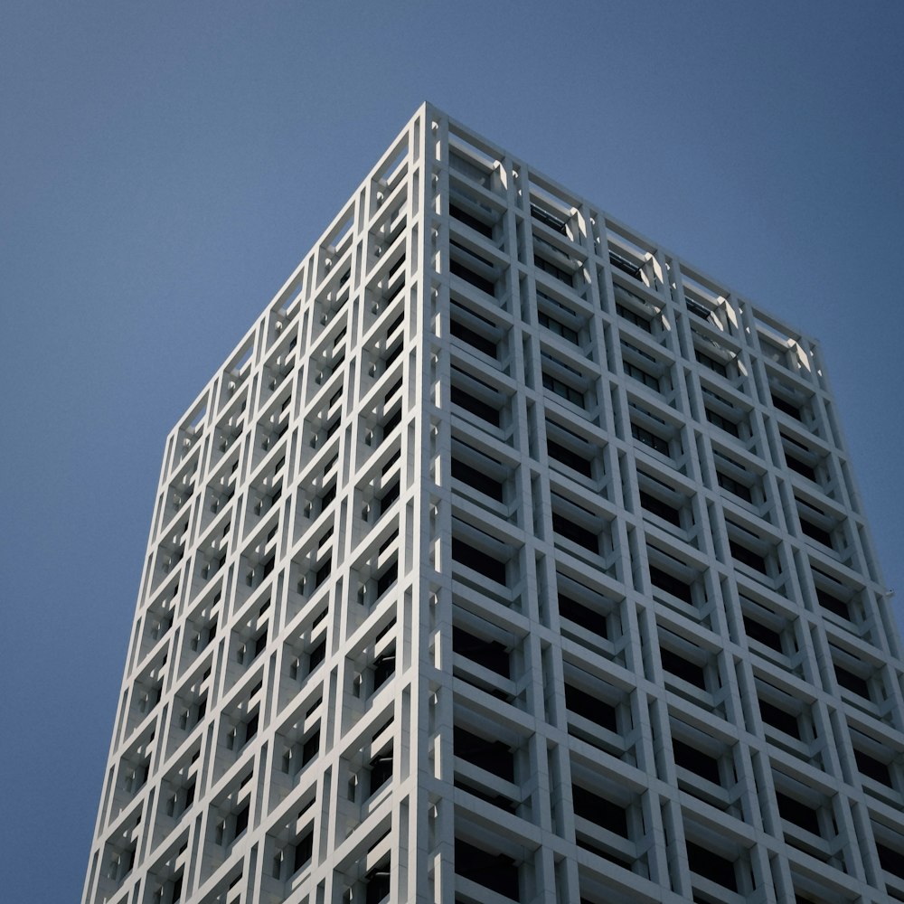 a tall white building with a sky in the background