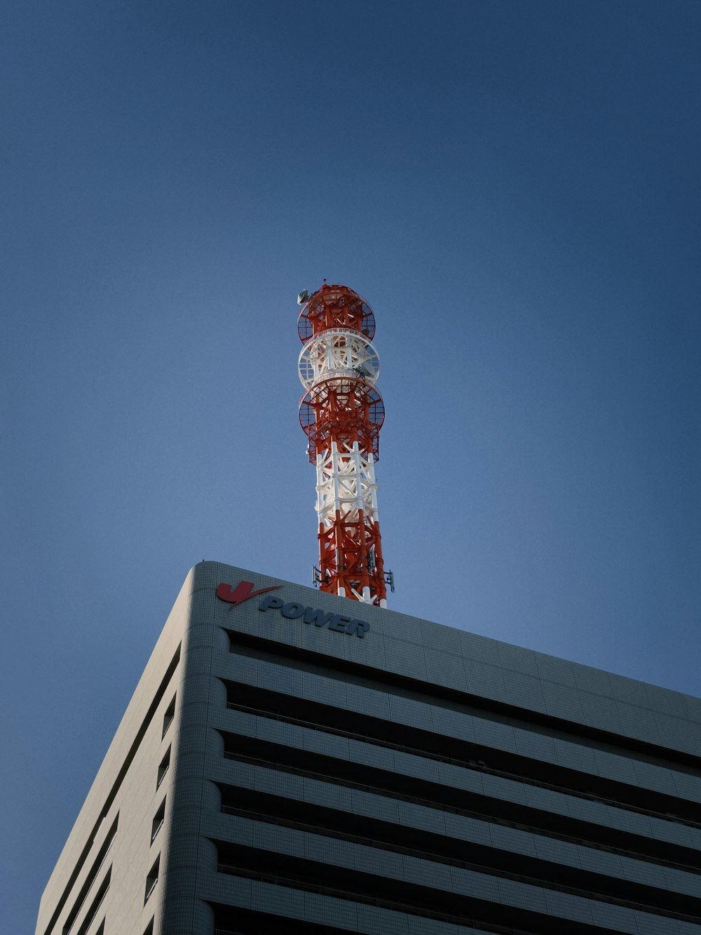 a red and white tower on top of a building
