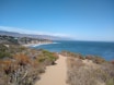a path leading to the beach on a sunny day