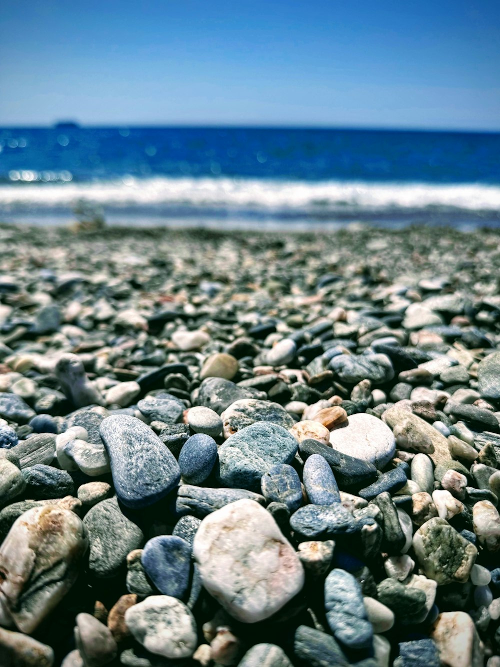a bunch of rocks that are on a beach