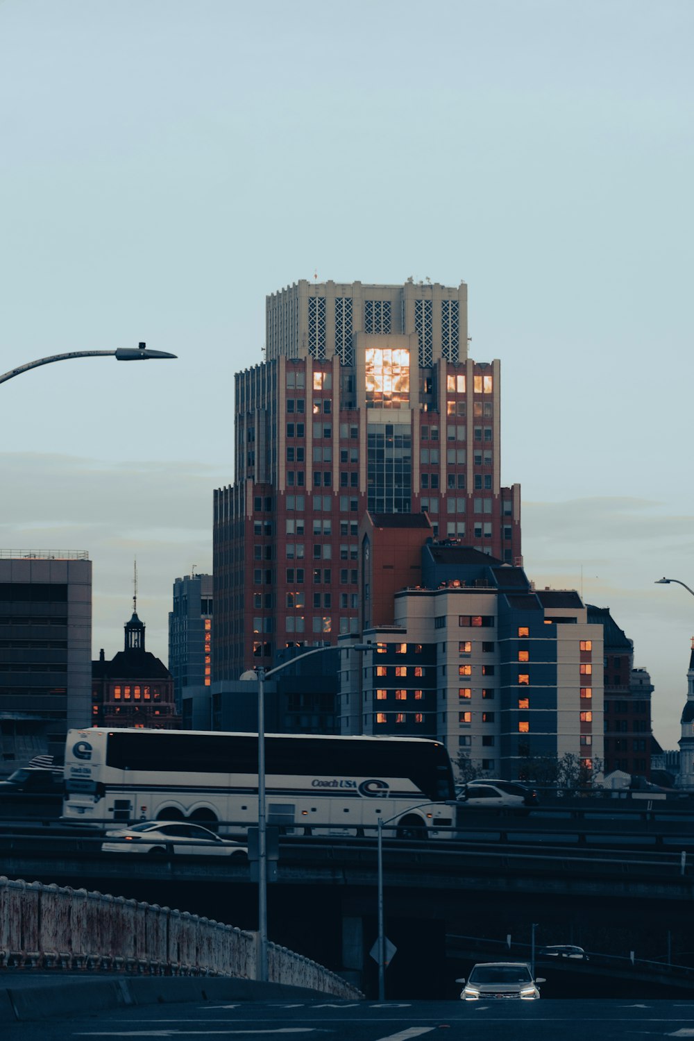 a city skyline with a bus on the road