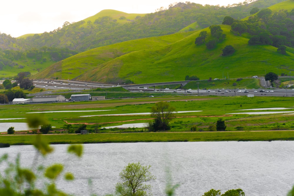 a large body of water surrounded by lush green hills