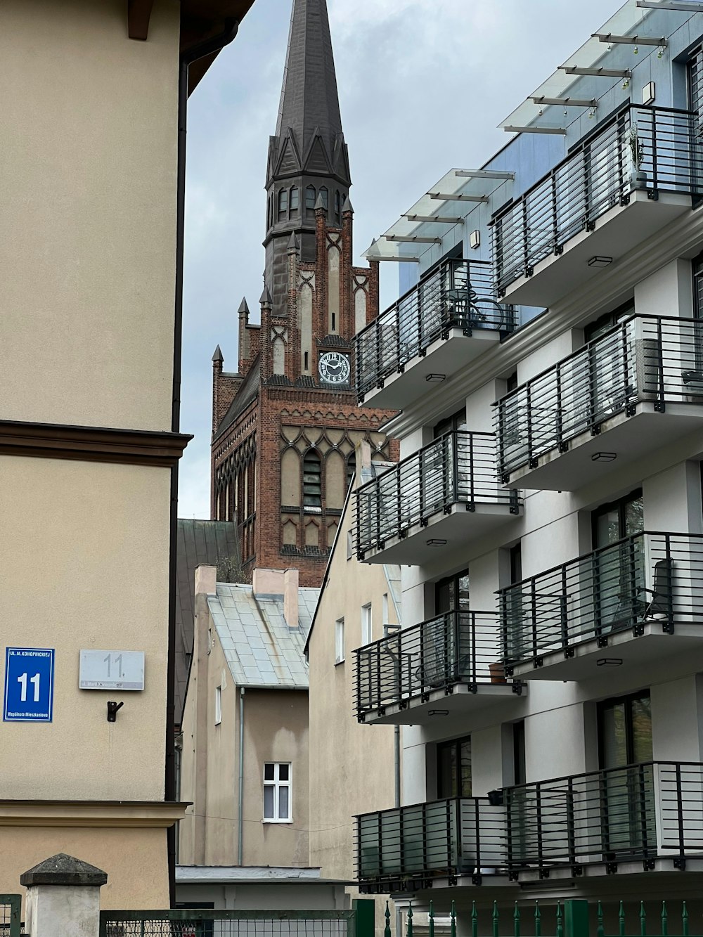 a tall building with a clock tower next to other buildings