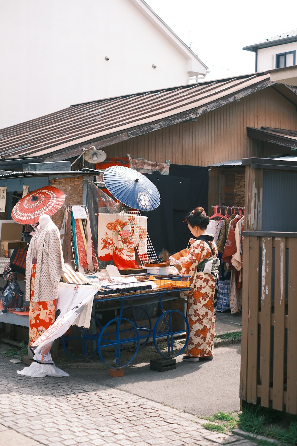 a group of people standing around a table with umbrellas