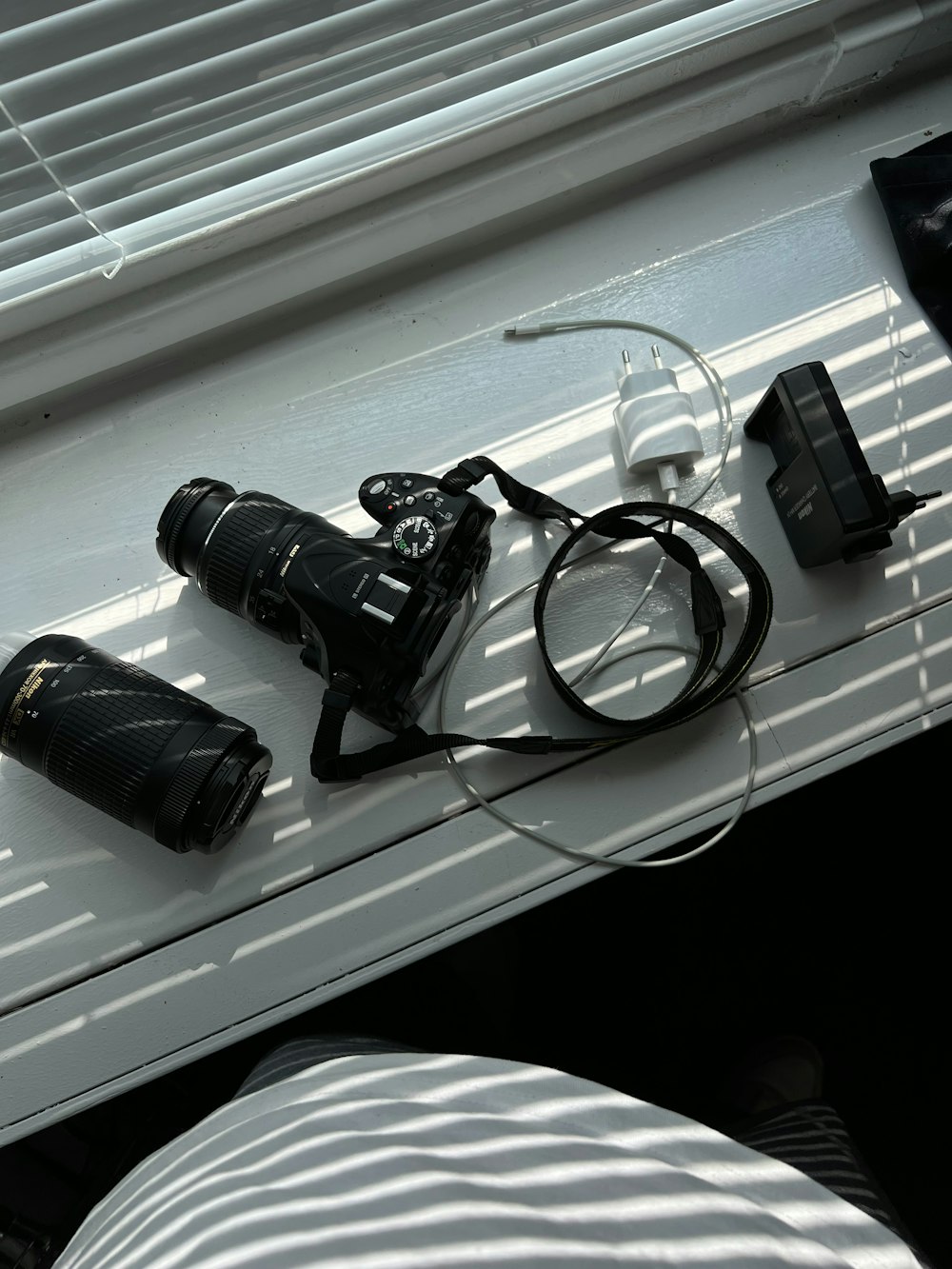 a couple of cameras sitting on top of a window sill