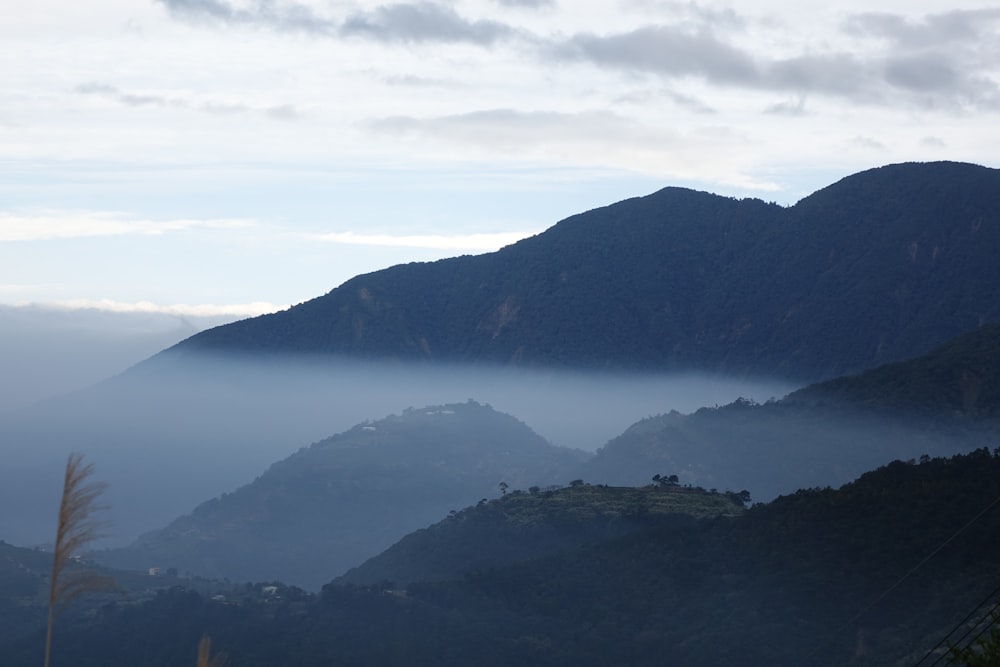 a view of a mountain range covered in fog