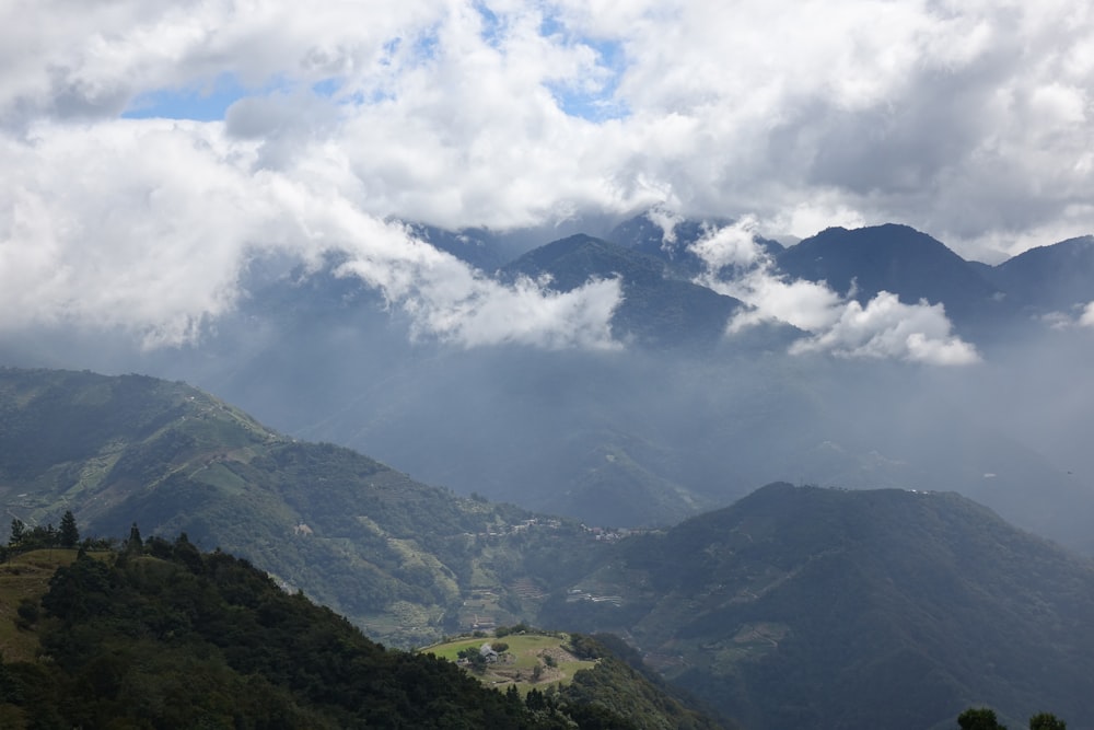 a view of a mountain range covered in clouds