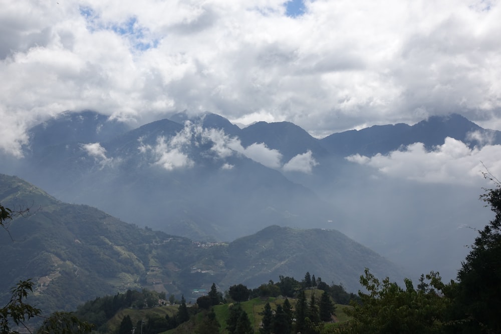 a view of a mountain range with clouds in the sky