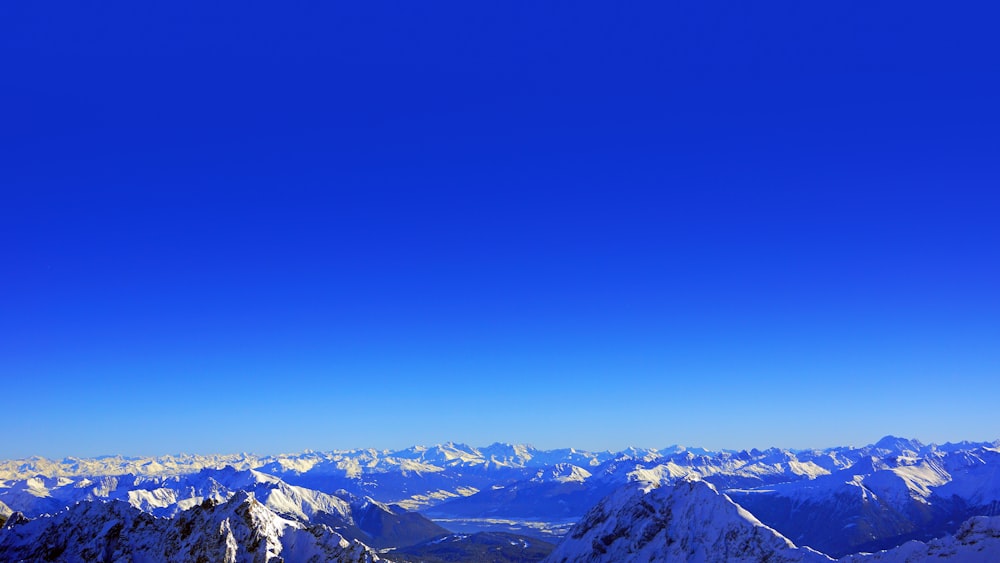 a view of a snowy mountain range from a ski lift