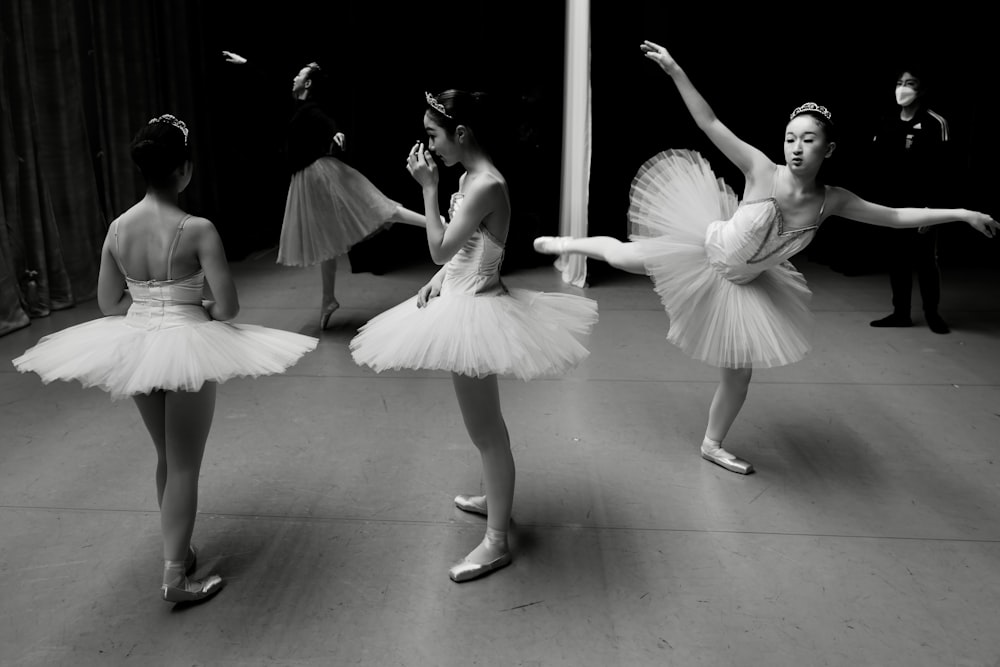 a black and white photo of a group of ballerinas