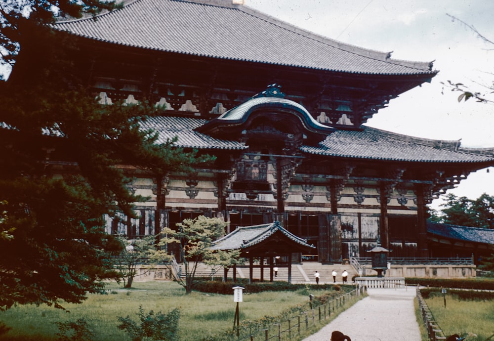 a large building with a long walkway in front of it