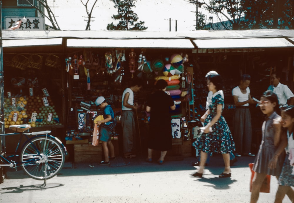 a group of people walking around a market