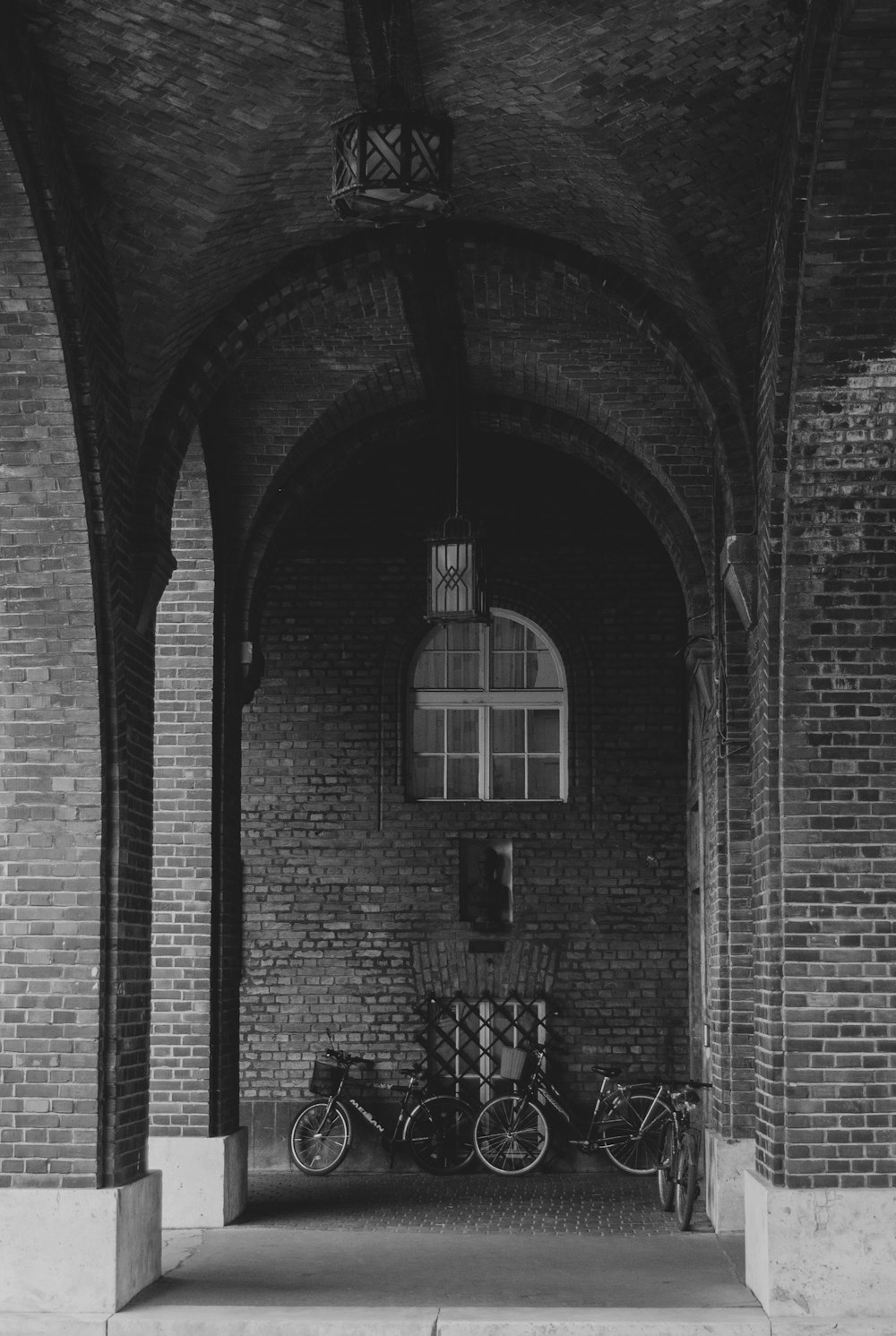 a black and white photo of bikes parked in a building