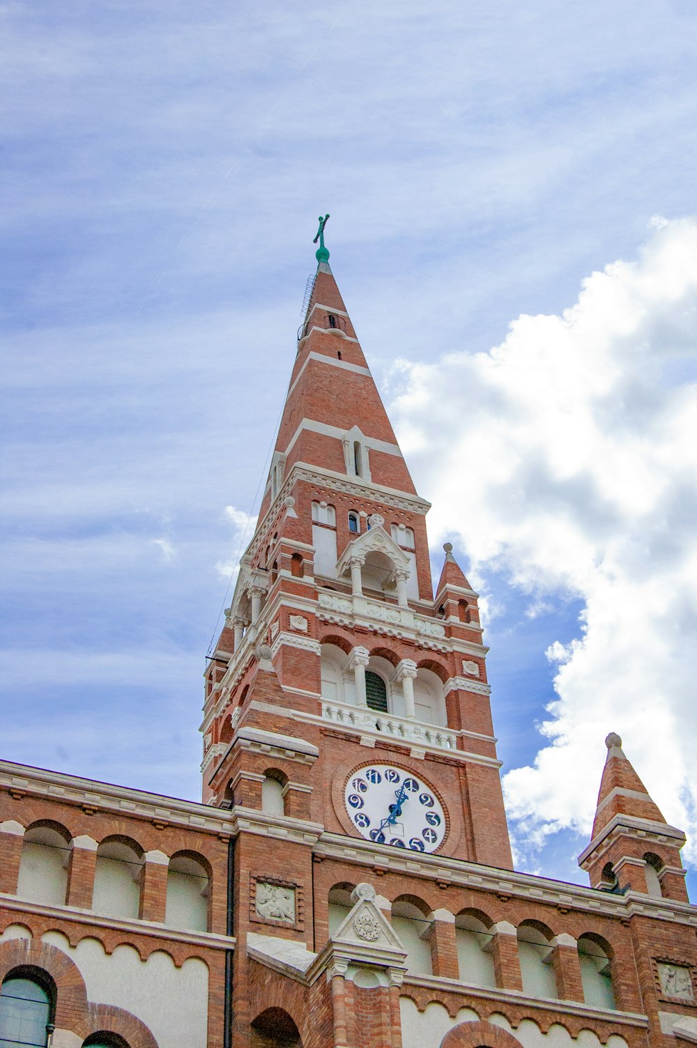 a tall brick building with a clock on it's side