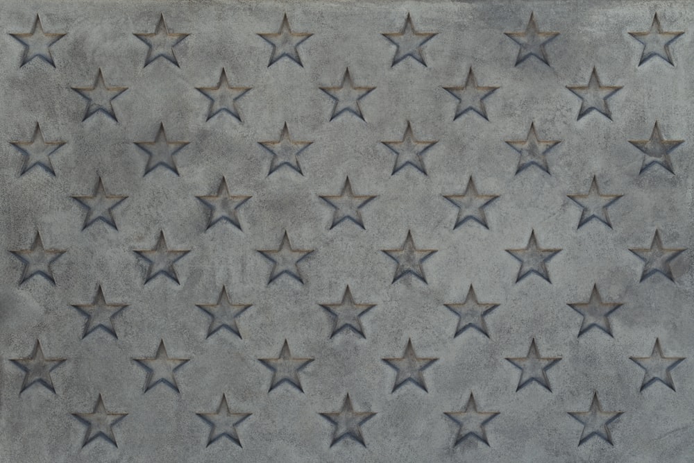 a gray rug with silver stars on it