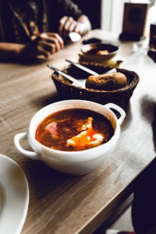 a bowl of soup sits on a table