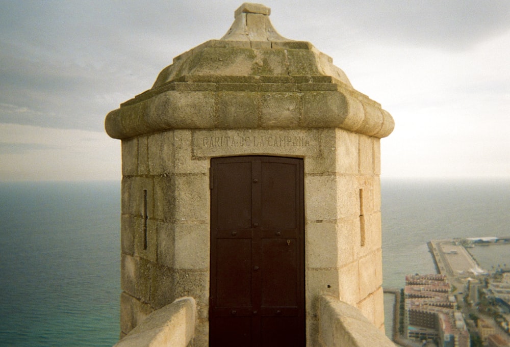 a stone tower with a door on top of it