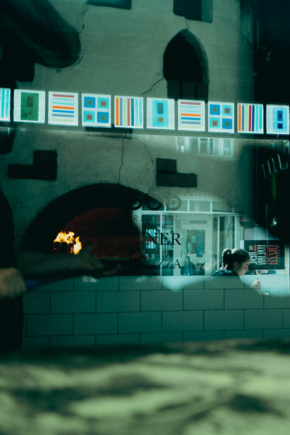 a person standing in front of a brick oven