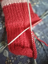 a close up of a knitted object on a bed