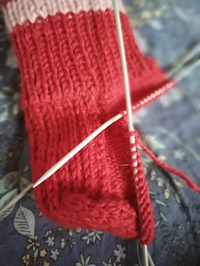 a close up of a knitted object on a bed