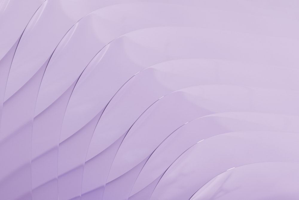 a close up of a purple background with wavy lines