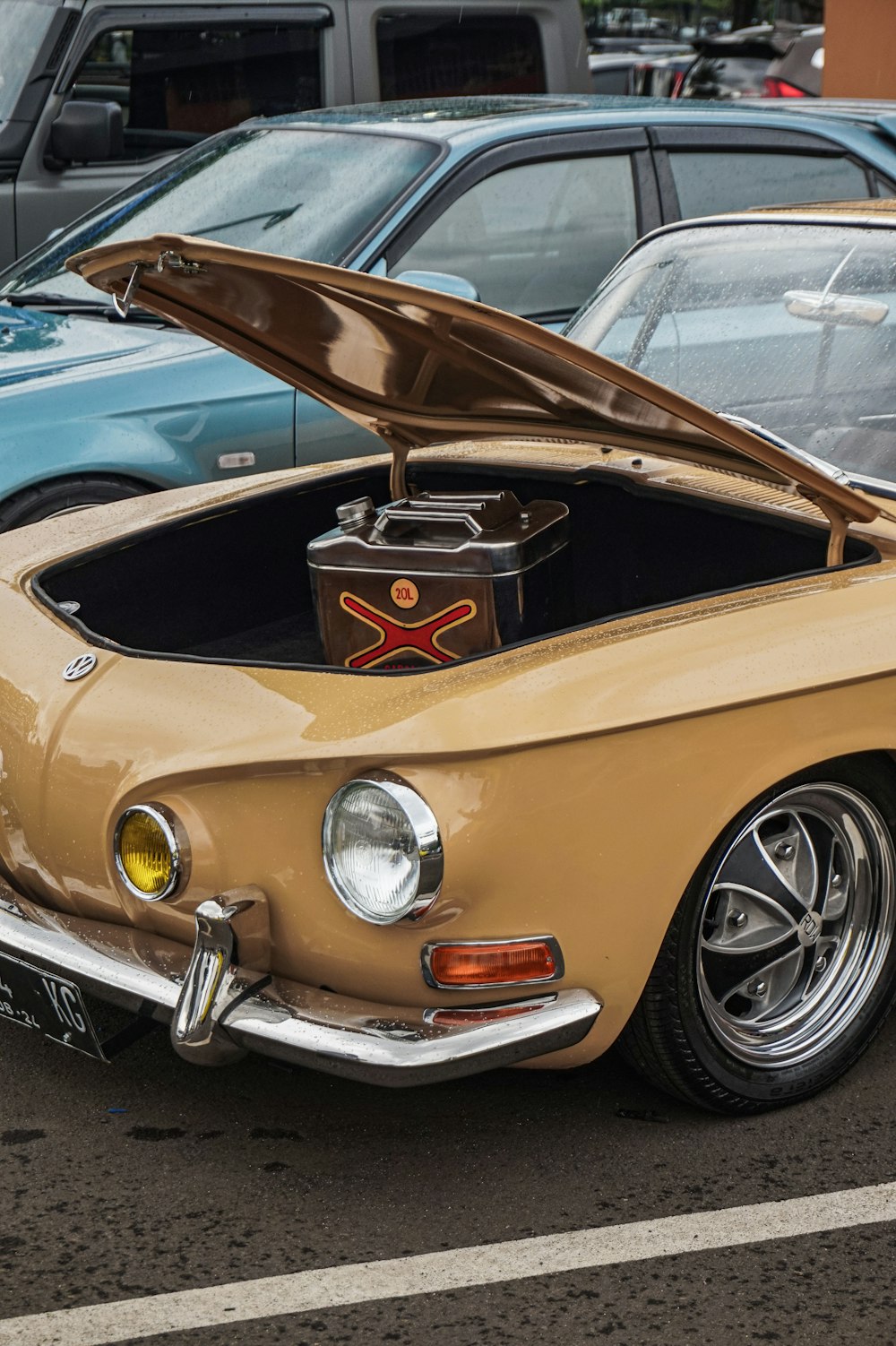 a car with a hood open in a parking lot