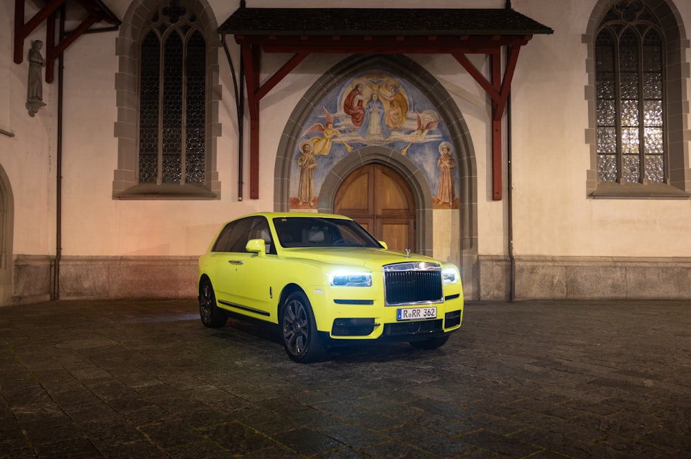 a yellow car parked in front of a building