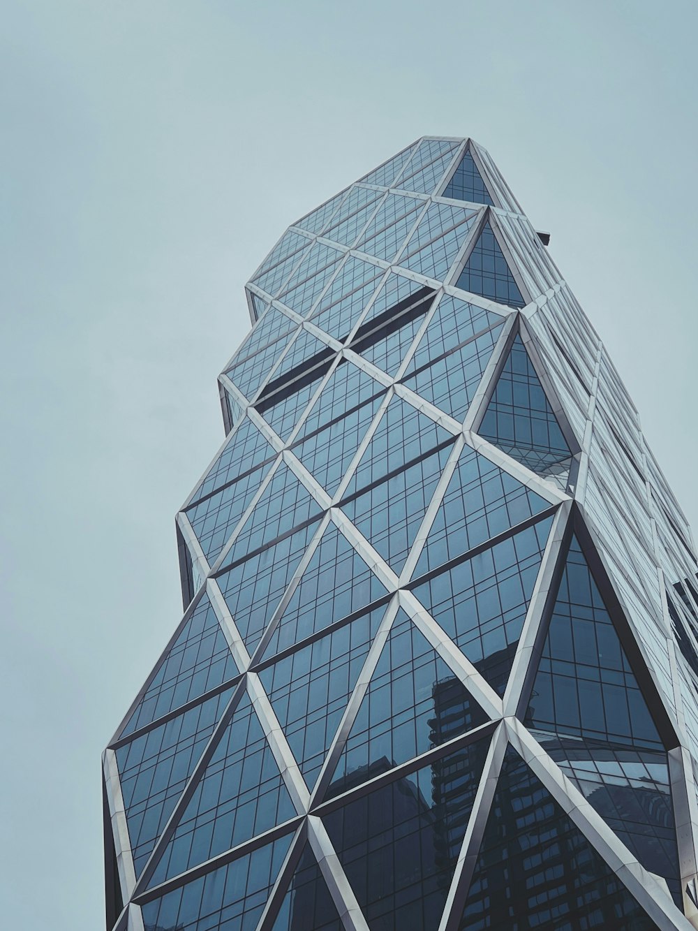 a very tall glass building with a sky background