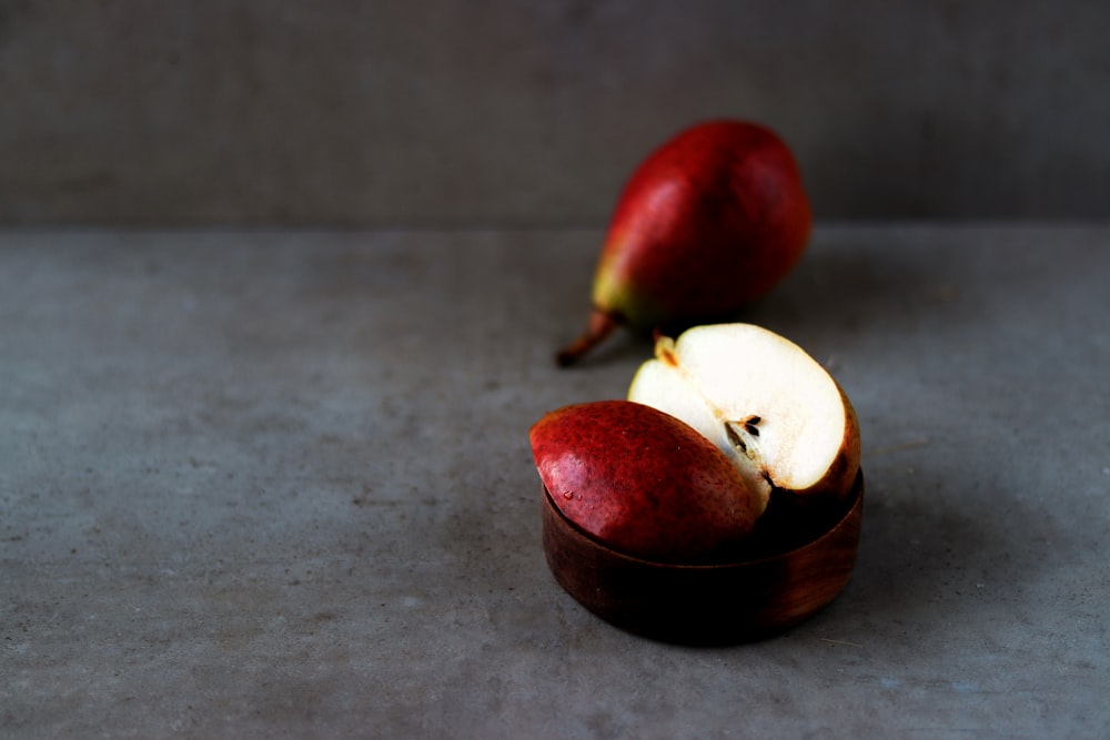 a couple of apples sitting on top of a table