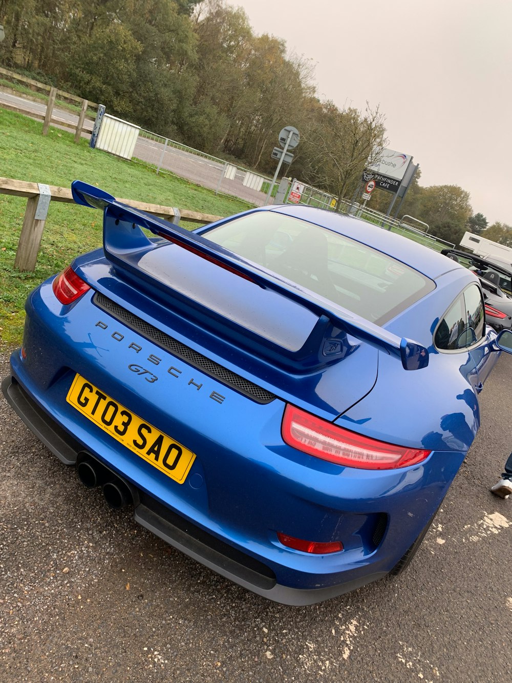 a blue sports car parked in a parking lot