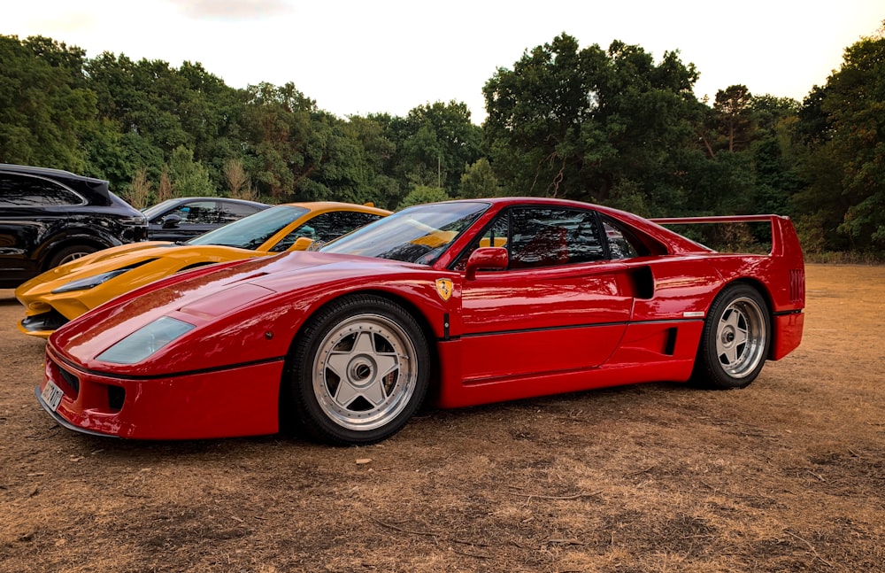 a red sports car parked next to a yellow sports car