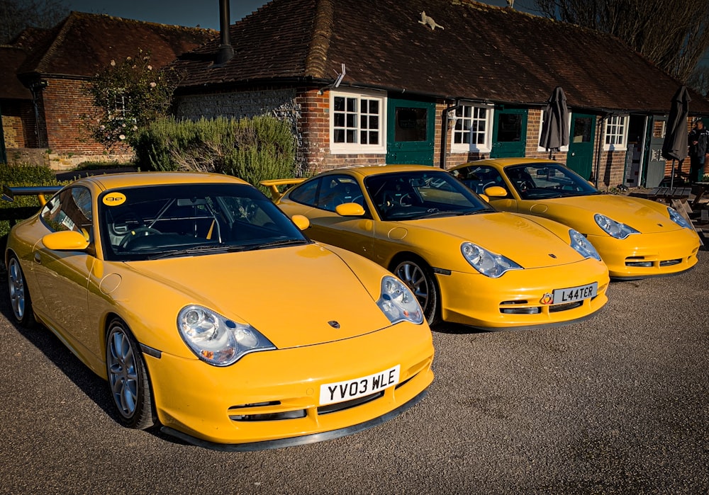 a row of yellow sports cars parked next to each other