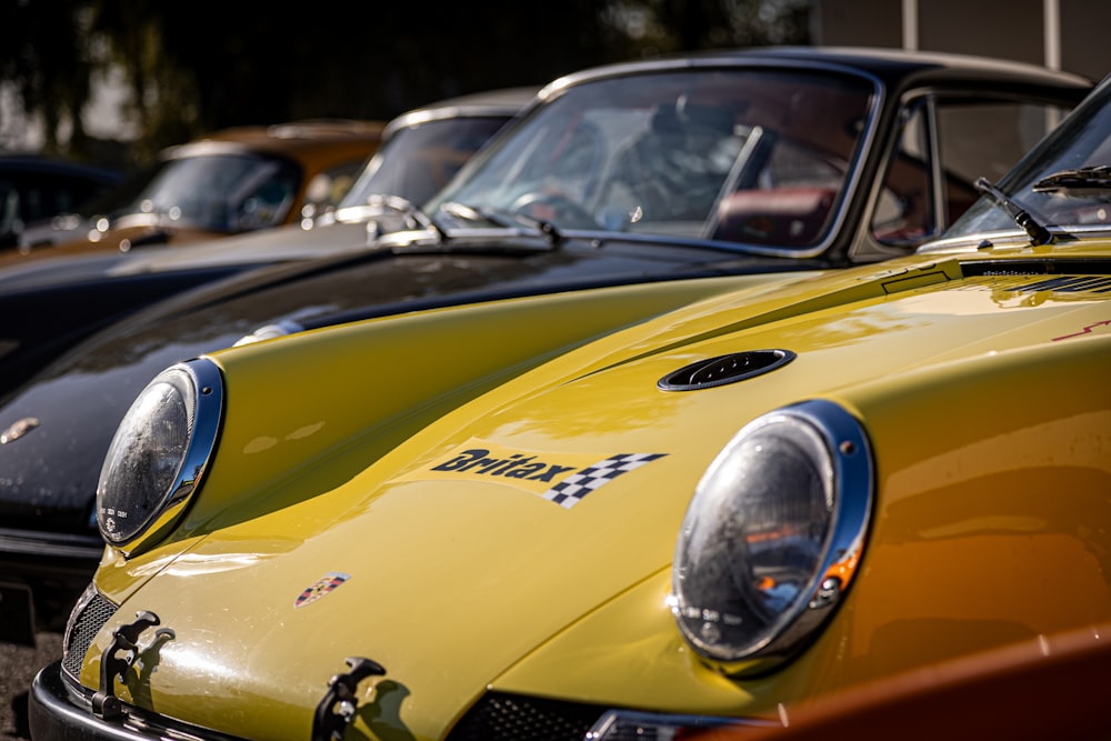 a row of classic cars parked next to each other