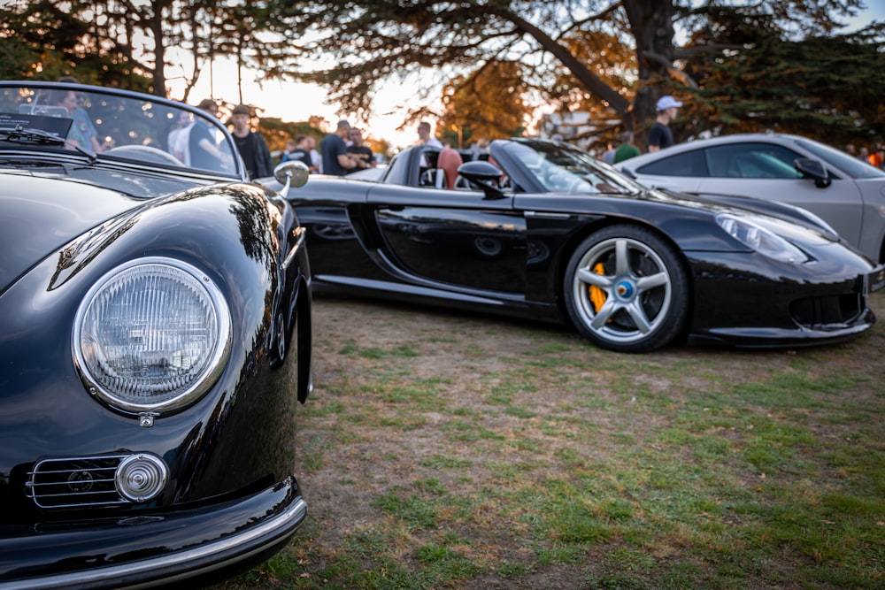 two black sports cars parked next to each other