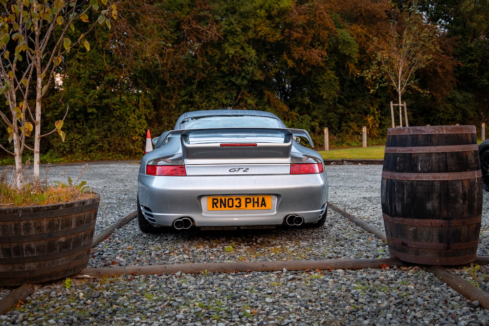 a silver sports car parked in a parking lot