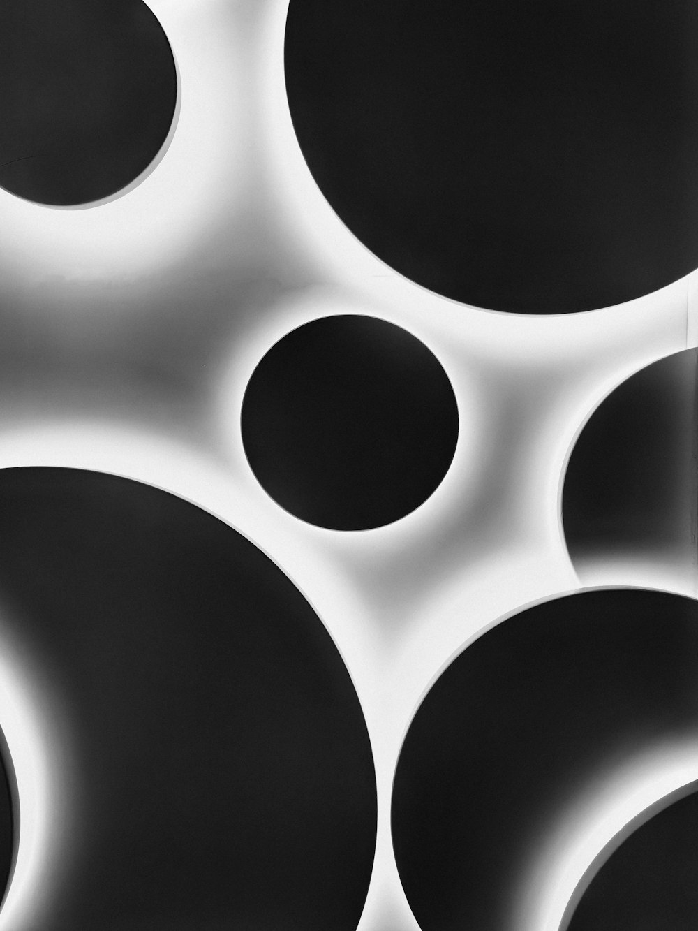 a black and white photo of circles on a wall