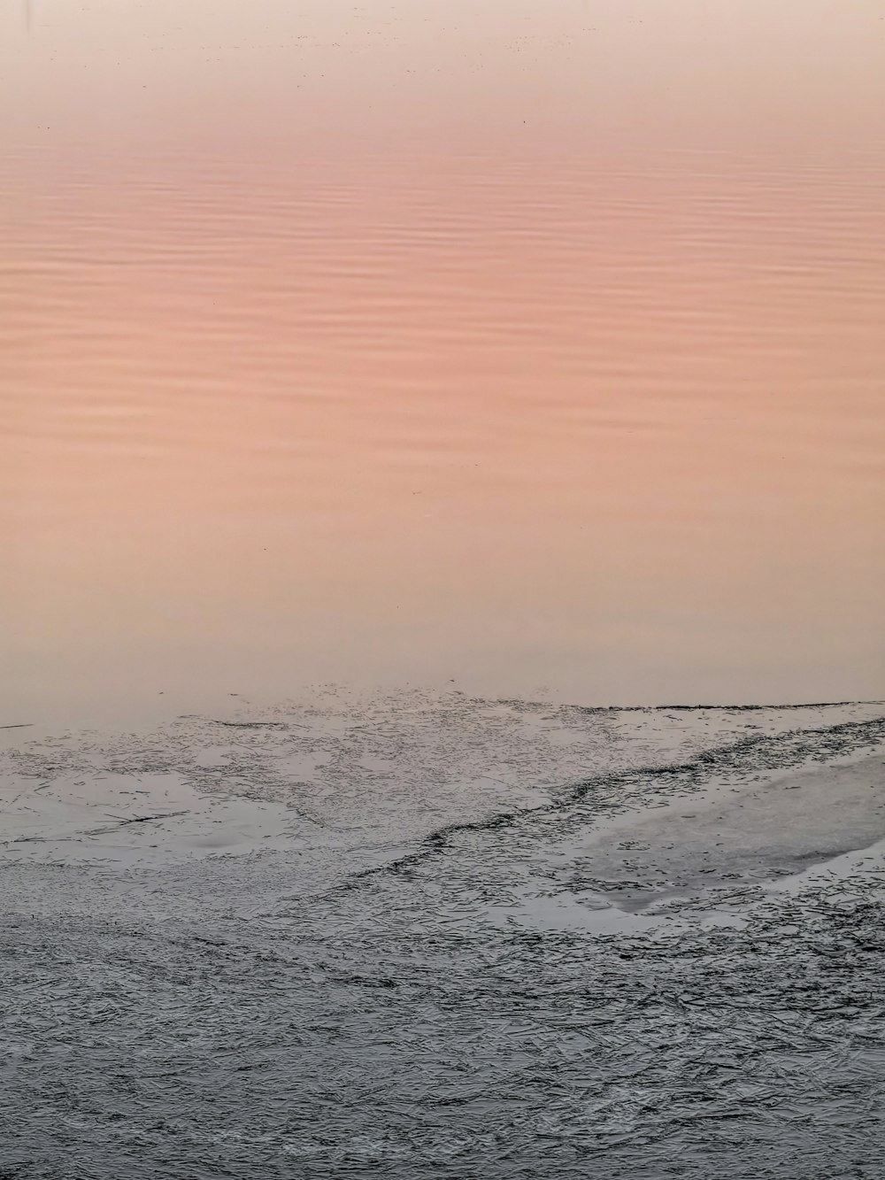 a lone boat floating in the middle of a body of water