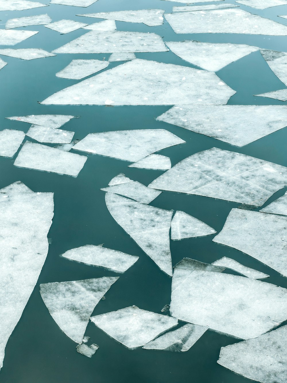 an aerial view of ice floes floating in the water